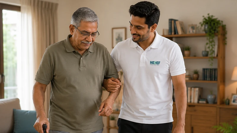 A physiotherapist assisting an elderly patient with home rehabilitation exercises in Bangalore